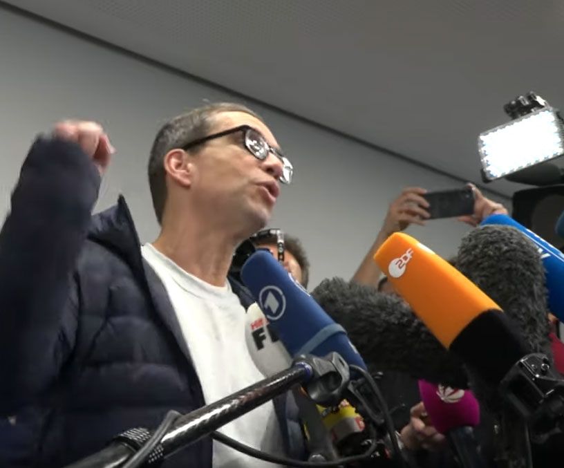 Jens Söring celebrating with supporters at a press conference after his arrival in Frankfurt.
