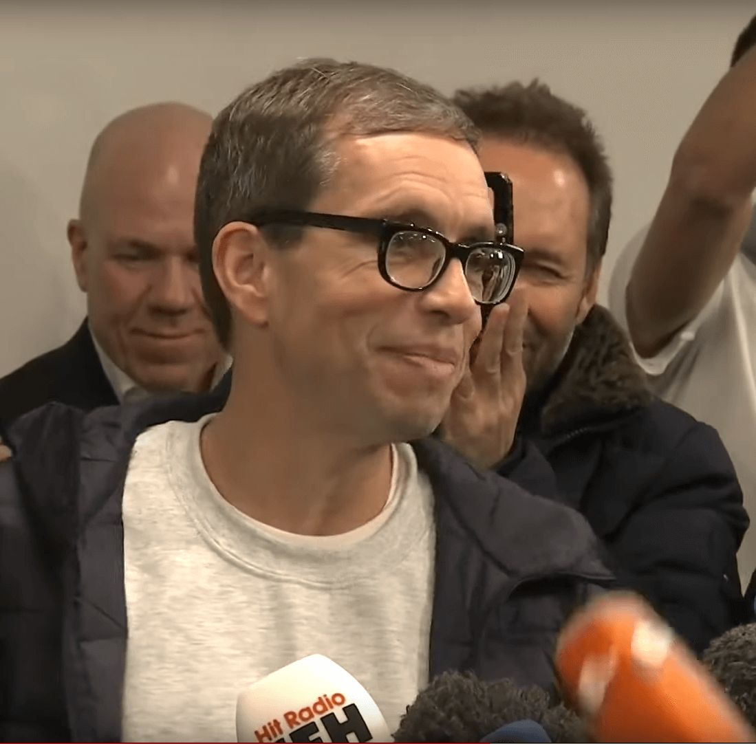 Jens Söring celebrating with supporters at a press conference after his arrival in Frankfurt.